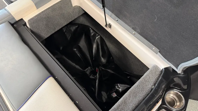 Slide: The Image of An open storage compartment on a boat with a black bag inside. - 17