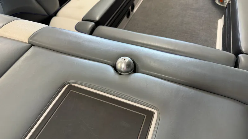 Slide: The Image of Close-up of a gray boat seat with a metal knob and built-in screen. - 19