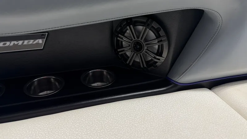 Slide: The Image of Close-up of a speaker and cup holders in the interior of a Moomba Mojo boat. - 47