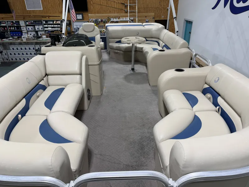 Slide: The Image of Interior of a 2014 Lowe SS 210 pontoon boat with beige and blue seating. - 7