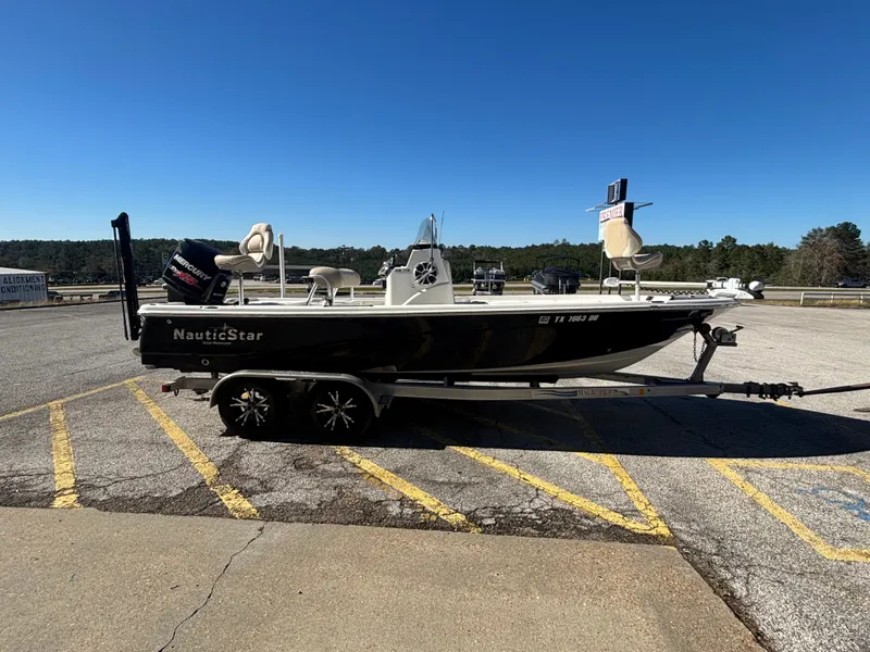 Slide: The Image of 2017 NauticStar 215 XTS boat parked on trailer outdoors. - 8