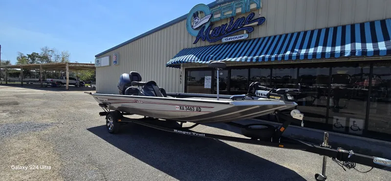 Slide: The Image of 2014 Ranger RT188 boat parked outside a marine shop. - 23