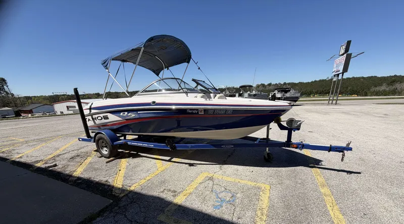 Slide: The Image of 2013 TAHOE Q5i boat parked on trailer outdoors. - 7