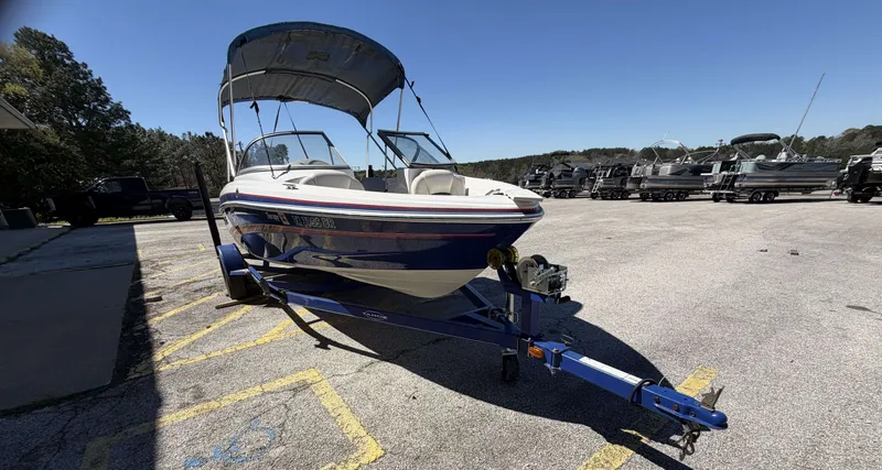 Slide: The Image of 2013 TAHOE Q5i boat on trailer parked outdoors. - 8