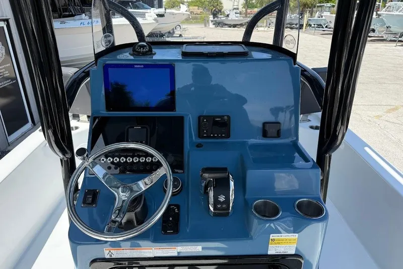 Slide: The Image of 2026 Sea Pro 250 Bay boat dashboard with steering wheel and control panel. - 11