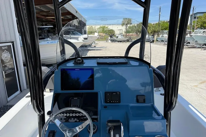 Slide: The Image of 2026 Sea Pro 250 Bay boat dashboard with steering wheel and navigation display. - 12