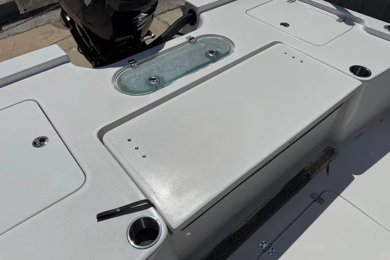 Slide: The Image of 2026 Sea Pro 250 Bay boat deck with storage compartments and motor. - 14