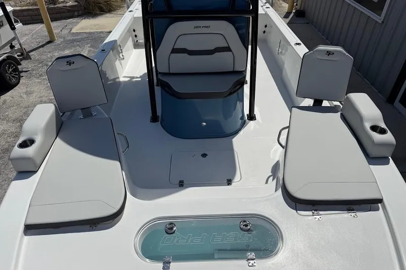 Slide: The Image of 2026 Sea Pro 250 Bay boat interior with seating and storage compartments. - 19