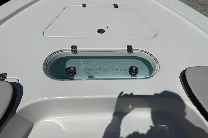 Slide: The Image of 2026 Sea Pro 250 Bay boat deck with livewell and seating area. - 21