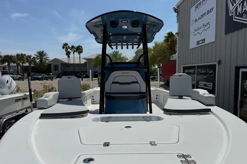 Slide: The Image of 2026 Sea Pro 250 Bay boat with seating and console, displayed outdoors. - 3