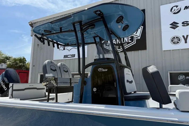 Slide: The Image of 2026 Sea Pro 250 Bay boat with T-top and seating, displayed outdoors. - 4