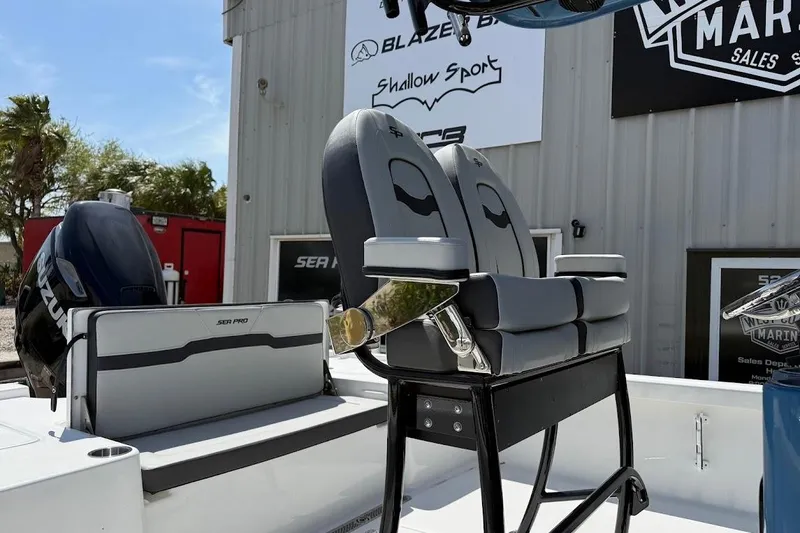 Slide: The Image of 2026 Sea Pro 250 Bay boat interior with seating and Suzuki engine. - 5