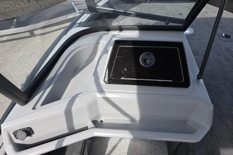 Slide: The Image of 2026 Smoker Craft Explorer 190 FS boat interior with storage compartment and windshield. - 20