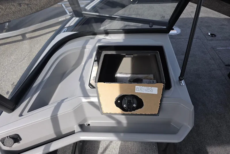 Slide: The Image of 2026 Smoker Craft Explorer 190 FS boat dashboard with open storage compartment. - 21