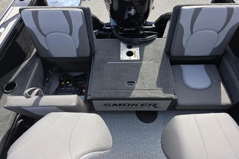 Slide: The Image of 2026 Smoker Craft Explorer 190 FS boat interior with gray seating and storage compartments. - 26