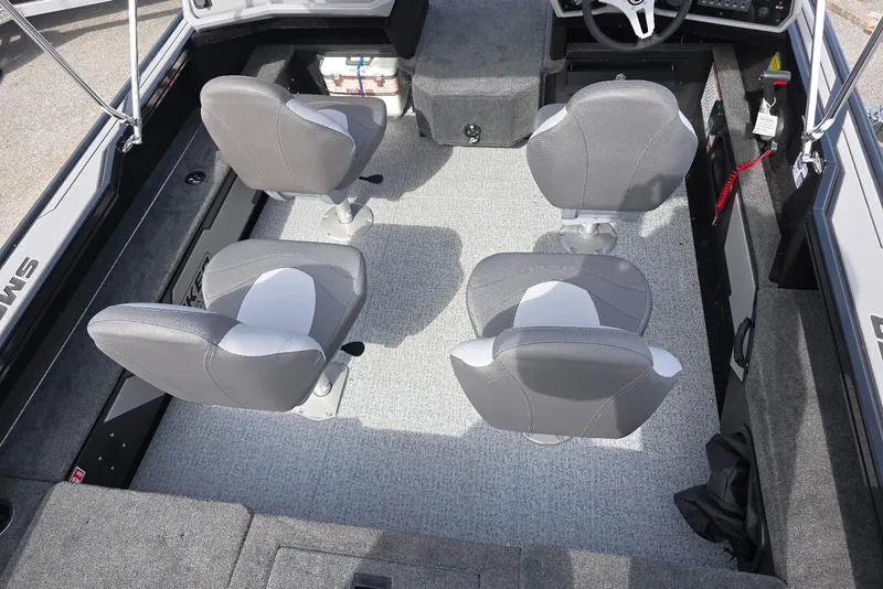 Slide: The Image of 2026 Smoker Craft Explorer 190 FS interior with four gray seats and steering console. - 7