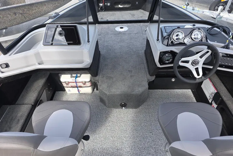 Slide: The Image of 2026 Smoker Craft Explorer 190 FS boat interior with steering wheel and seating. - 8