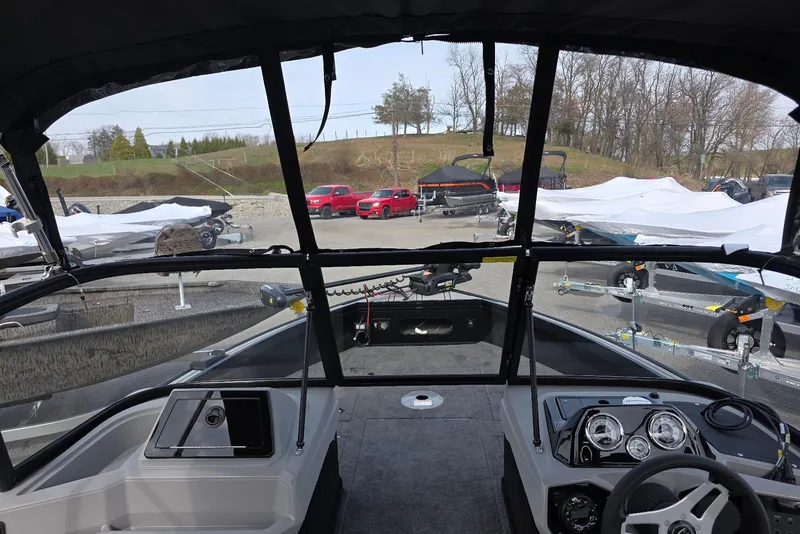 Slide: The Image of 2026 Smoker Craft Explorer 190 FS boat interior with dashboard and windshield view. - 9