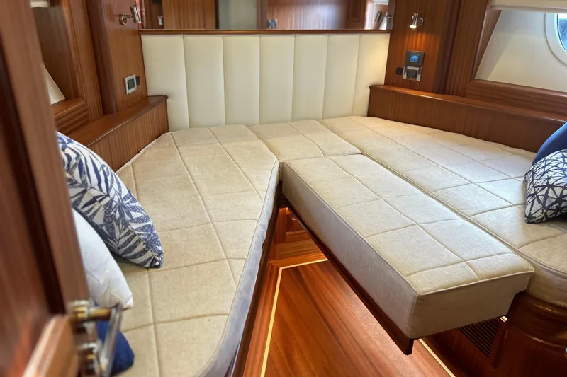 Slide: The Image of Luxurious interior of 2026 Vicem 55 Classic yacht with elegant bedding and wood finish. - 12