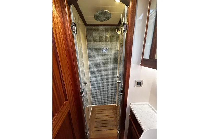 Slide: The Image of Vicem 55 Classic 2026 yacht shower with wood accents and modern tile design. - 14