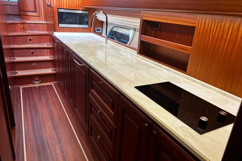 Slide: The Image of Luxurious galley interior of 2026 Vicem 55 Classic yacht with wood cabinetry and modern appliances. - 7