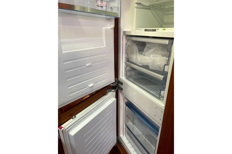 Slide: The Image of Open refrigerator inside 2026 Vicem 55 Classic yacht, showcasing storage compartments. - 9