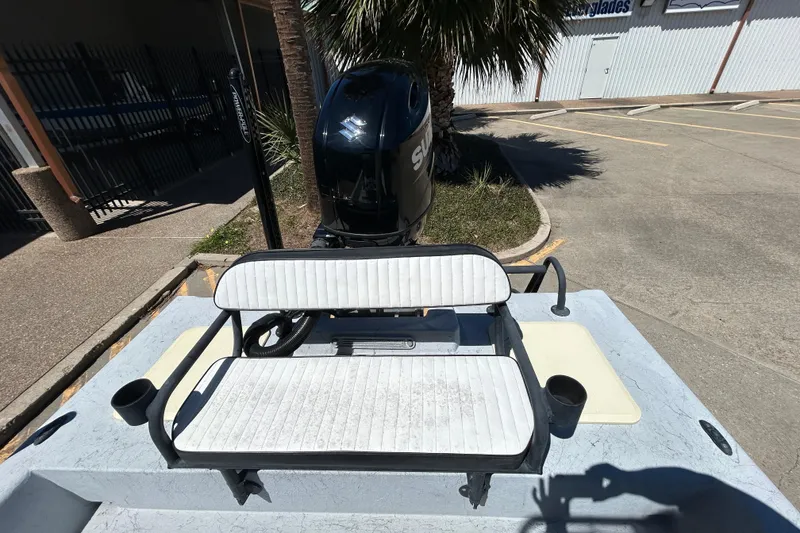 Slide: The Image of 2022 Stoner Super Cat boat with Suzuki outboard motor and white seating. - 13