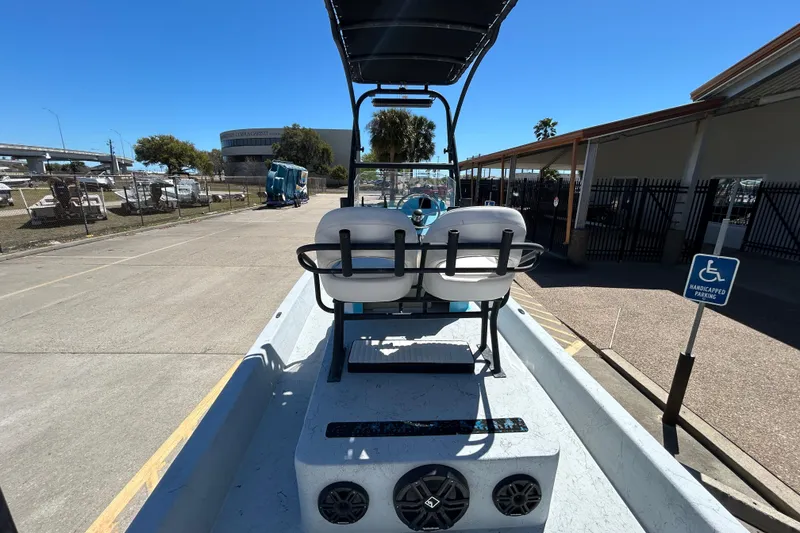 Slide: The Image of 2022 Stoner Super Cat boat parked near a marina with clear blue skies. - 15