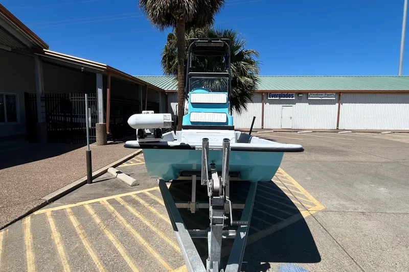 Slide: The Image of 2022 Stoner Super Cat boat on trailer in parking lot, sunny day. - 2