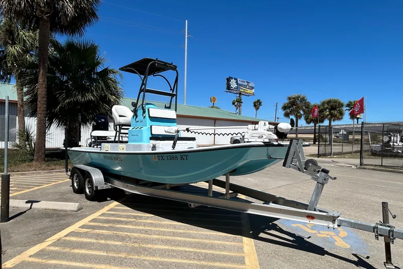 Slide: The Image of 2022 Stoner Super Cat boat on trailer in sunny parking lot. - 3