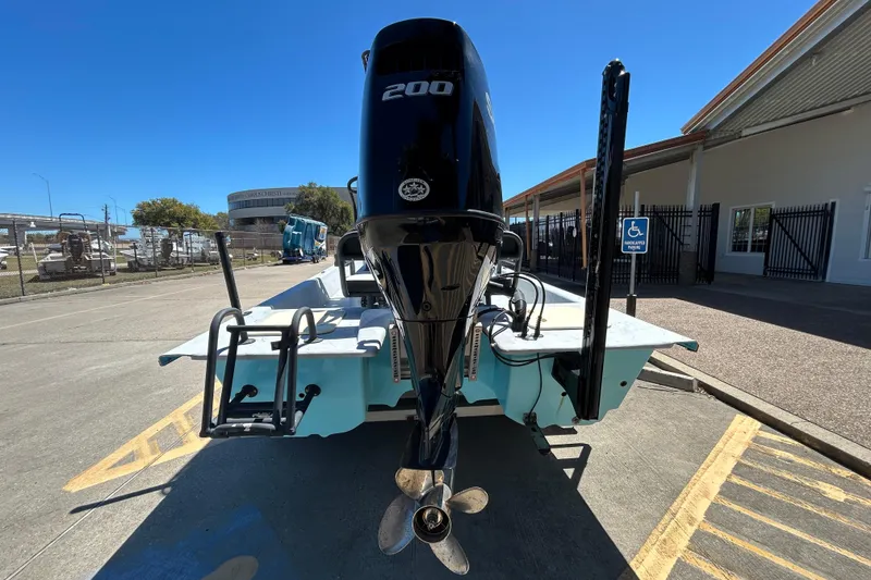 Slide: The Image of 2022 Stoner Super Cat boat with powerful 200 HP engine, parked outdoors. - 5