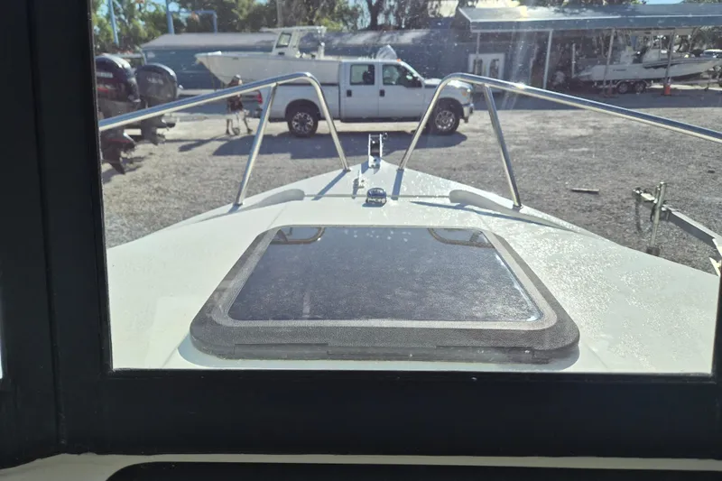 Slide: The Image of 2026 Arima 21 HT Sea Ranger boat on trailer, side view in sunlight. - 1