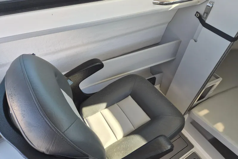 Slide: The Image of Interior cabin of 2026 Arima 21 HT Sea Ranger boat, featuring cushioned seating. - 13