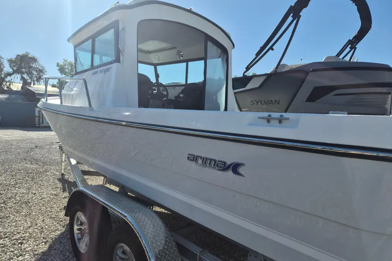 Slide: The Image of Spacious deck of 2026 Arima 21 HT Sea Ranger boat with seating and storage. - 3