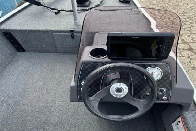 Slide: The Image of 2019 Tracker Bass Tracker Classic XL boat dashboard with steering wheel and navigation display. - 14