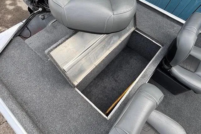 Slide: The Image of 2019 Tracker Bass Tracker Classic XL boat interior with open storage compartment and gray seating. - 19