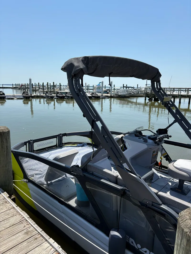 Slide: The Image of 2022 Sea-Doo Switch Sport 18 docked on a sunny day. - 13