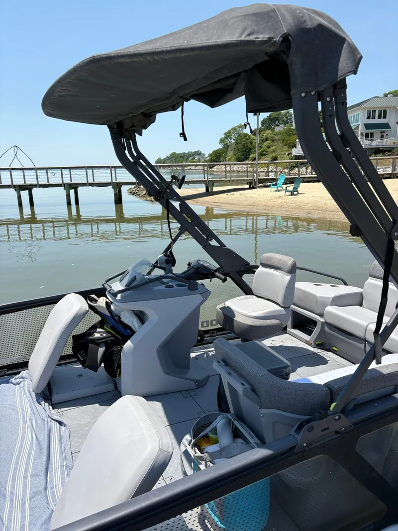 Slide: The Image of 2022 Sea-Doo Switch Sport 18 pontoon boat by the beach. - 14