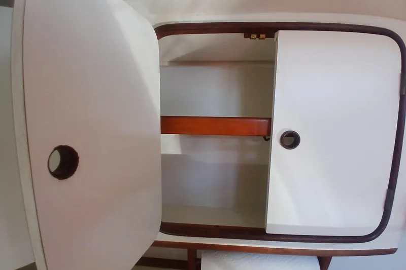 Slide: The Image of Interior cabinet of 1981 Gulfstar 44 yacht with wooden trim and white doors. - 13