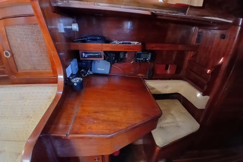 Slide: The Image of 1981 Gulfstar 44 yacht interior with wooden navigation station and seating area. - 16
