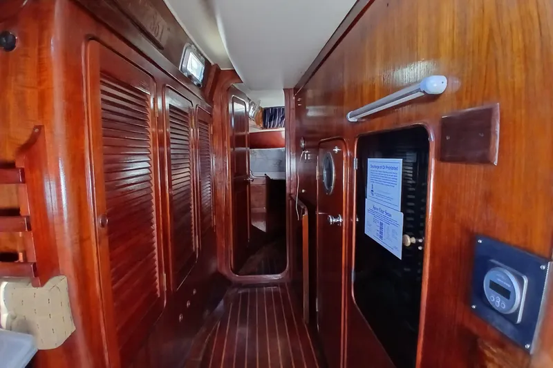 Slide: The Image of Interior of 1981 Gulfstar 44 yacht with wooden paneling and cozy cabin space. - 17