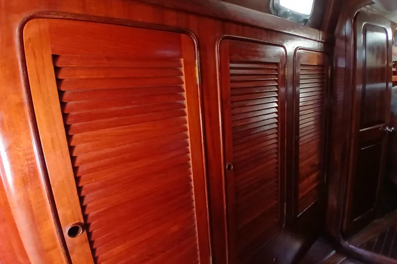 Slide: The Image of Interior of 1981 Gulfstar 44 yacht featuring polished wooden louvered doors. - 18