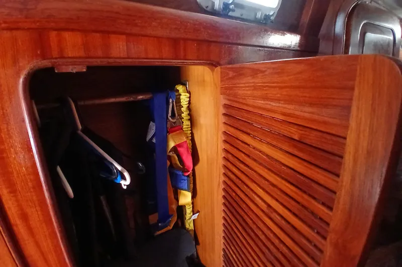Slide: The Image of Wooden closet interior on a 1981 Gulfstar 44 yacht with colorful life jackets. - 19