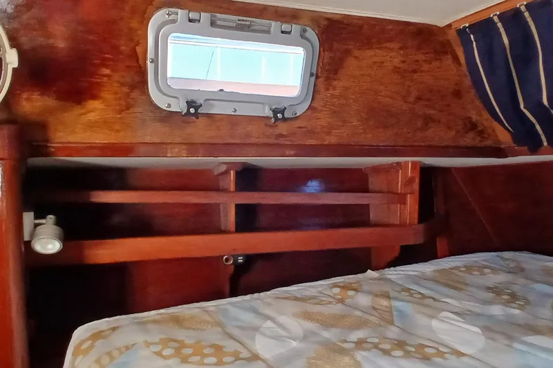 Slide: The Image of Interior cabin of 1981 Gulfstar 44 sailboat with wooden finish and porthole window. - 23