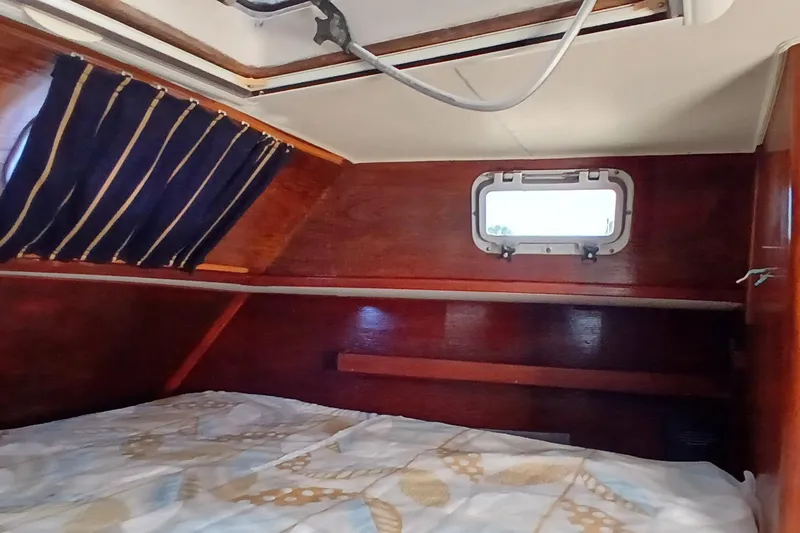 Slide: The Image of Cozy cabin interior of 1981 Gulfstar 44 sailboat with wooden finish and small window. - 24