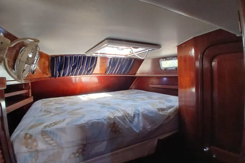 Slide: The Image of Cozy cabin interior of 1981 Gulfstar 44 sailboat with wooden finish and bed. - 25
