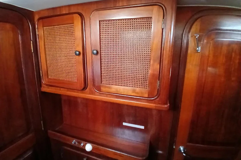 Slide: The Image of Interior of 1981 Gulfstar 44 yacht featuring wooden cabinetry with woven panel doors. - 26