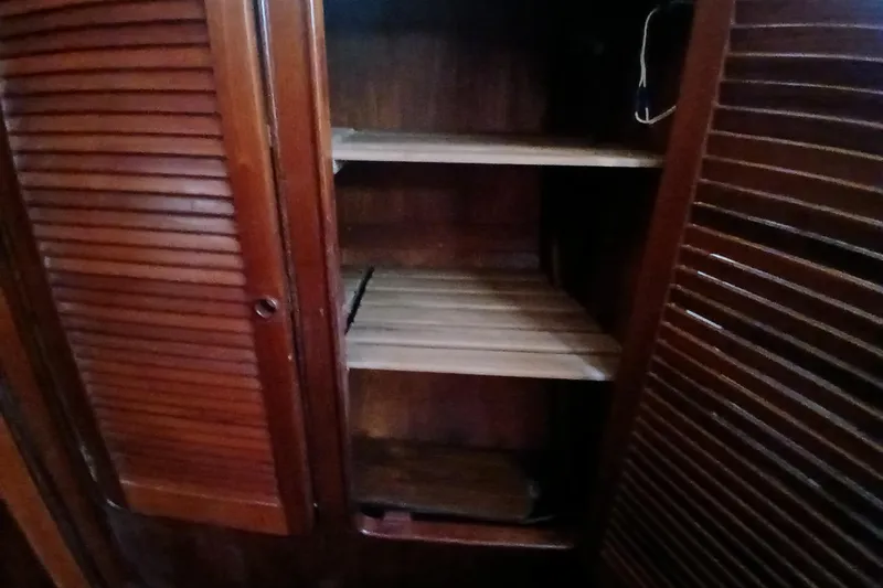 Slide: The Image of Wooden cabinet with open louvered doors on a 1981 Gulfstar 44 yacht. - 27
