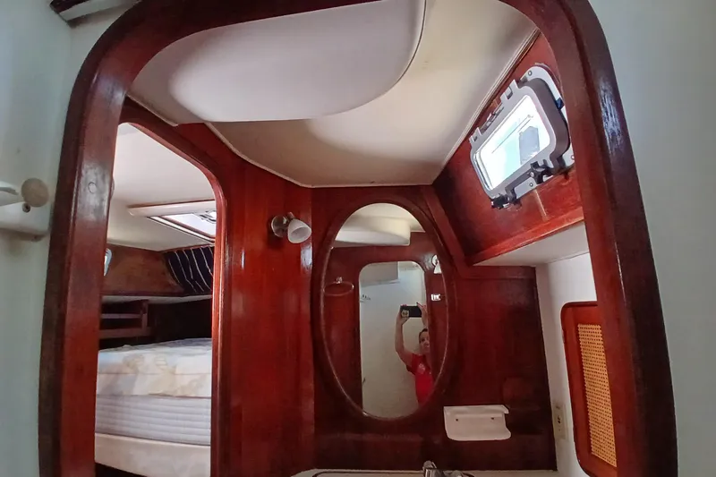 Slide: The Image of Interior of 1981 Gulfstar 44 yacht with wooden finish and oval mirror. - 30