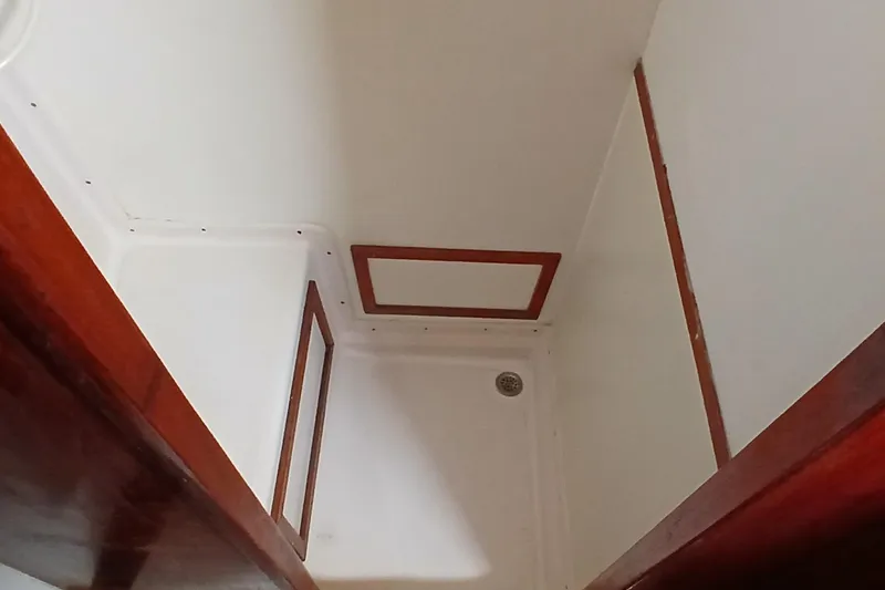 Slide: The Image of Interior view of 1981 Gulfstar 44 sailboat with wooden trim and white walls. - 31